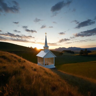 White chapel on hill at sunset