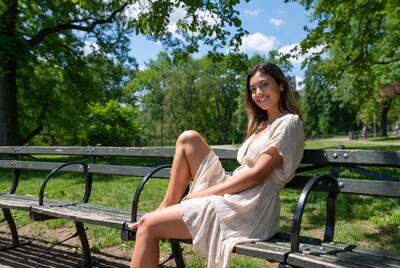 Asian woman sitting on park bench