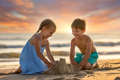 Boy and girl building sandcastle on beach