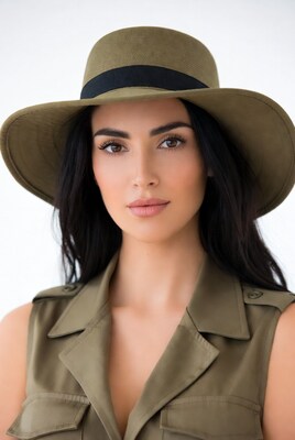 Woman wearing green hat and vest