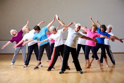Senior group doing aerobics in studio