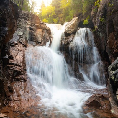Waterfall cascading between rocky cliffs