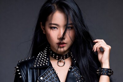 Asian woman in spiked leather jacket