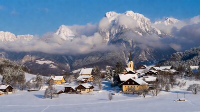 Snowy Alpine Village with Church and Mountains