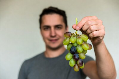 Man holding grapes