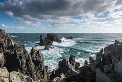 Ocean waves crashing on rocky coast