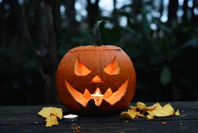 Lit Jack-o-Lantern on Wooden Table