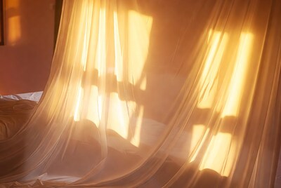 Sheer curtains with sunlight in bedroom