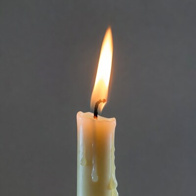 Burning Candle with Dripping Wax