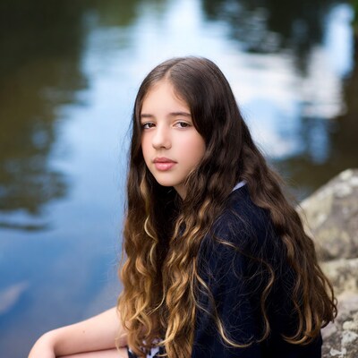 Girl with long hair by lake