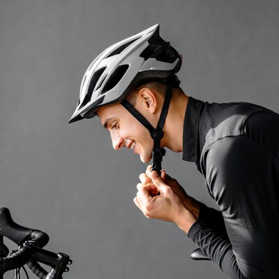 Man adjusting bike helmet