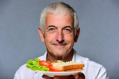 Senior man holding sandwich plate