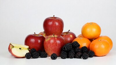 Red apples, oranges, blackberries pile