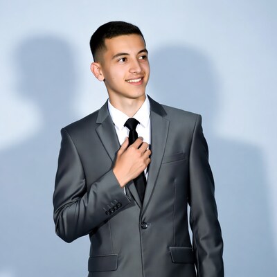 Young man adjusting tie in suit