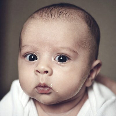 Newborn baby with drool on lips