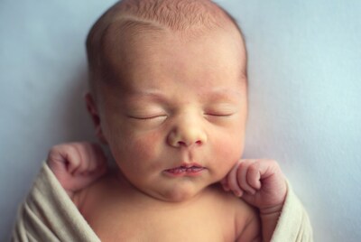 Newborn baby sleeping in swaddle