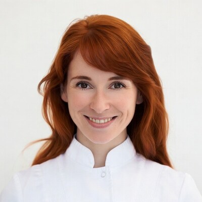 Smiling redhead woman in white uniform