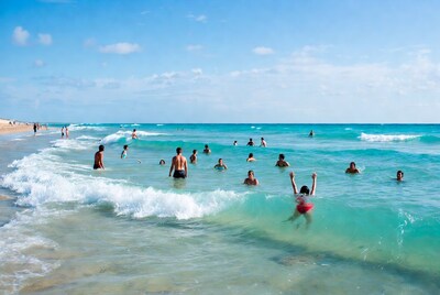 Crowd swimming in turquoise ocean waves