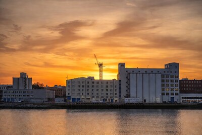 Industrial Silos at Sunset by River