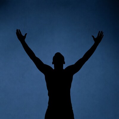 Man silhouette raising arms