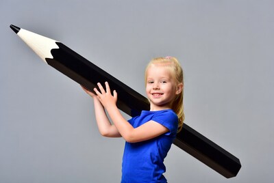 Girl holding giant pencil