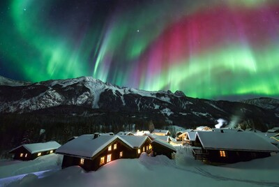 Northern Lights over Snowy Mountain Cabins