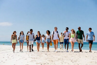 Diverse group walking on beach