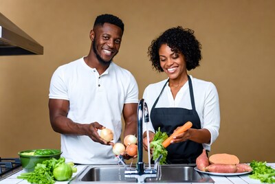 African-American couple washing vegetables
