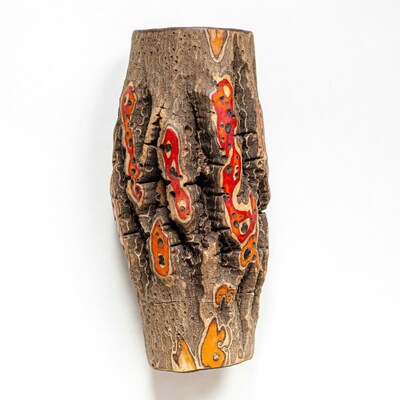 Textured wooden vase with orange accents