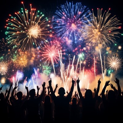 Crowd cheering at colorful fireworks display