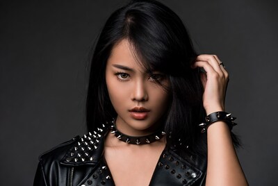 Asian woman in spiked leather jacket