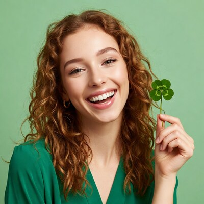 Woman holding four-leaf clover