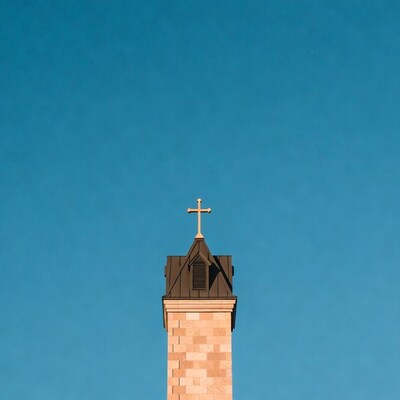 Church Steeple with Cross on Blue Sky