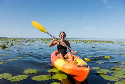 Woman kayaking in lily pads