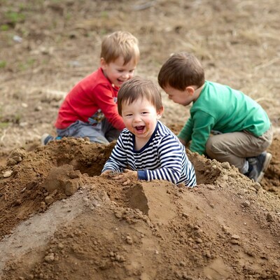 Boys playing in dirt pile