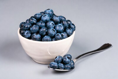Blueberries in white bowl with spoon