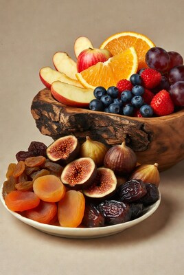 Fresh fruit in wooden bowl and dried fruit plate