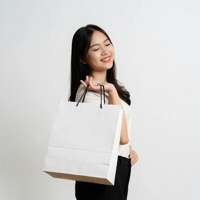 Asian woman holding white shopping bag