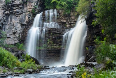 Majestic Waterfall Cascading Over Rocky Cliffs
