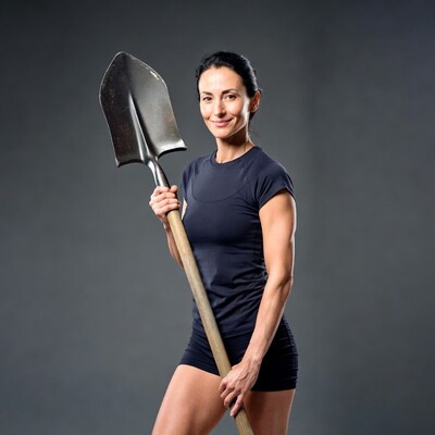 Muscular woman holding shovel