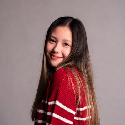 Asian girl smiling in red sweater
