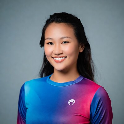 Smiling Asian woman in blue pink shirt