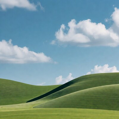 Green rolling hills under blue sky