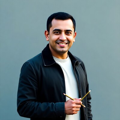 Smiling man holding two pencils