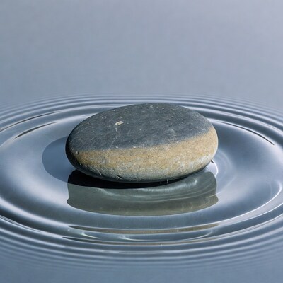 Stone Rippling Calm Water Surface