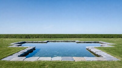 Stone-edged pool in green yard