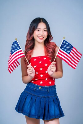 Asian woman holding American flags
