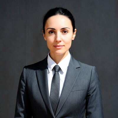 Woman in gray suit and tie