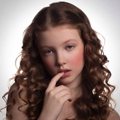 Girl thinking with finger on lips