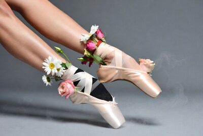 Ballerina legs with flowers on pointe shoes